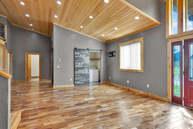 26 Two Rivers Rd, Saint Regis, MT 59866 - foyer with a barn door, washer / clothes dryer, wooden ceiling, wood finished floors, and recessed lighting