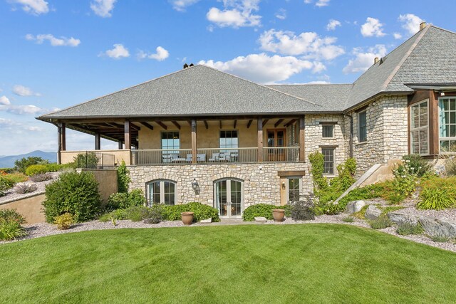 2761 Contour Rd, Missoula, MT 59802 - back of house featuring stone siding, a balcony, a yard, french doors, and stucco siding
