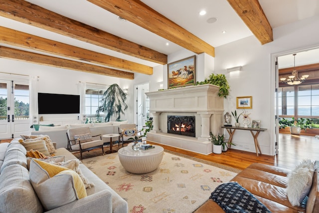 2761 Contour Rd, Missoula, MT 59802 - living room with wood finished floors, a chandelier, beam ceiling, a lit fireplace, and recessed lighting