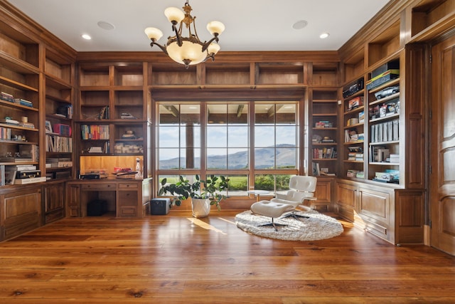 2761 Contour Rd, Missoula, MT 59802 - living area featuring a chandelier, an office area, built in shelves, wood finished floors, and wooden walls