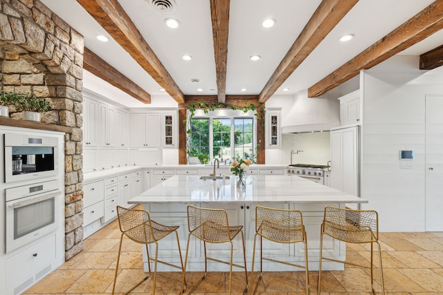 2761 Contour Rd, Missoula, MT 59802 - kitchen featuring white appliances, stone tile flooring, beamed ceiling, custom range hood, and recessed lighting
