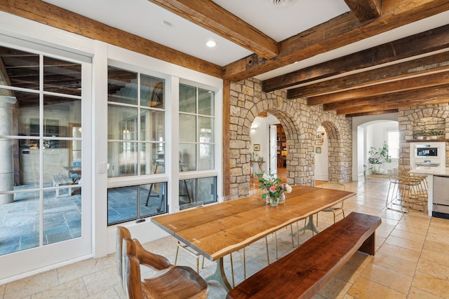 2761 Contour Rd, Missoula, MT 59802 - dining area with arched walkways, beam ceiling, and stone tile flooring