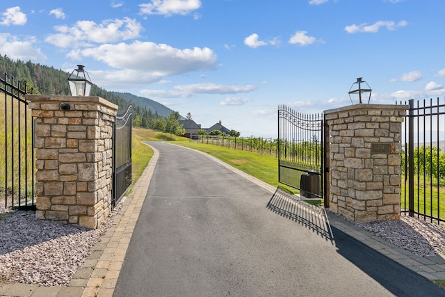 2761 Contour Rd, Missoula, MT 59802 - view of asphalt road featuring a gate and street lighting