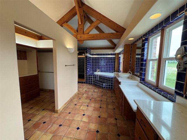 444 Windwalker Trl, Stevensville, MT 59870 - bathroom with a garden tub, tile patterned floors, vanity, beam ceiling, and high vaulted ceiling