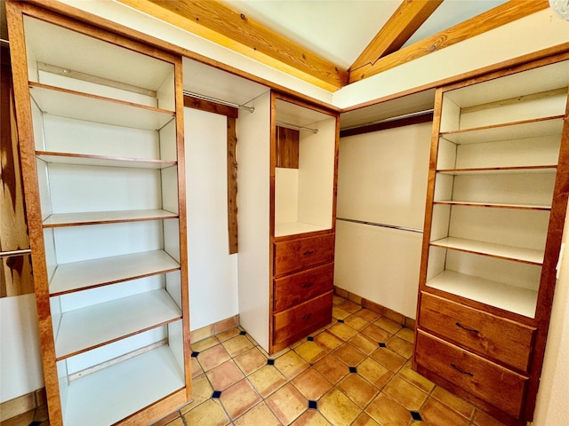 444 Windwalker Trl, Stevensville, MT 59870 - spacious closet featuring lofted ceiling and tile patterned flooring