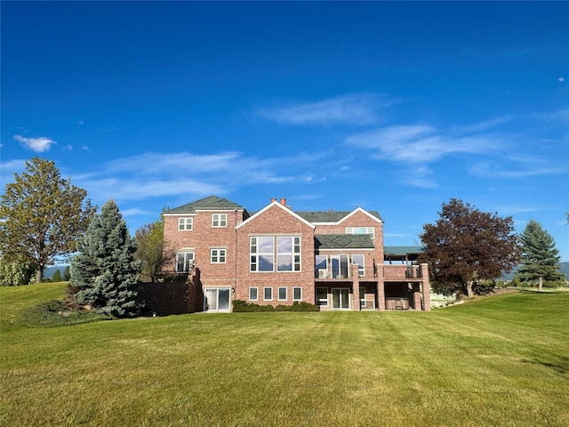 444 Windwalker Trl, Stevensville, MT 59870 - back of house featuring brick siding and a lawn