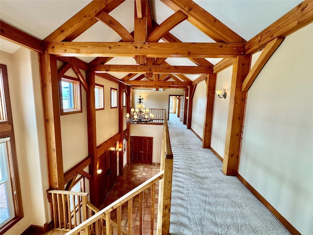 444 Windwalker Trl, Stevensville, MT 59870 - corridor featuring a chandelier, healthy amount of natural light, an upstairs landing, and carpet flooring