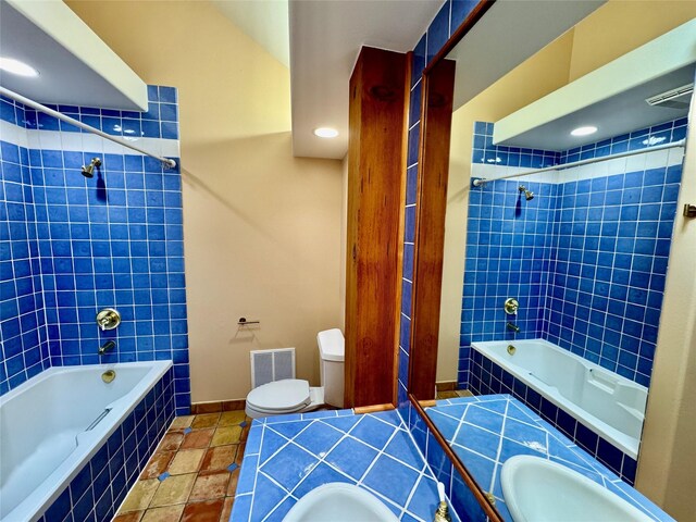 444 Windwalker Trl, Stevensville, MT 59870 - full bathroom featuring tiled shower / bath combo, toilet, baseboards, and tile patterned flooring