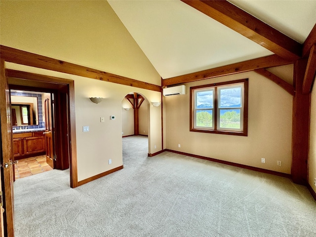 444 Windwalker Trl, Stevensville, MT 59870 - empty room featuring light colored carpet, a wall unit AC, arched walkways, baseboards, and high vaulted ceiling