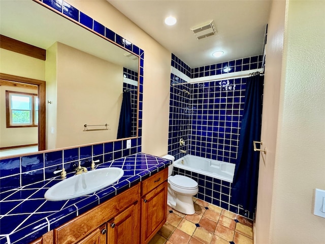 444 Windwalker Trl, Stevensville, MT 59870 - full bathroom featuring vanity, tile patterned flooring, toilet, tiled shower / bath combo, and tasteful backsplash