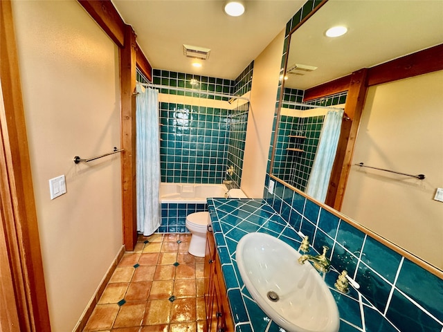 444 Windwalker Trl, Stevensville, MT 59870 - bathroom with tiled shower / bath combo, tile patterned flooring, toilet, vanity, and recessed lighting
