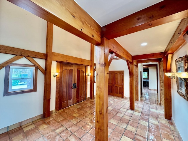 444 Windwalker Trl, Stevensville, MT 59870 - entryway with healthy amount of natural light, arched walkways, beamed ceiling, baseboards, and light stone finish floors