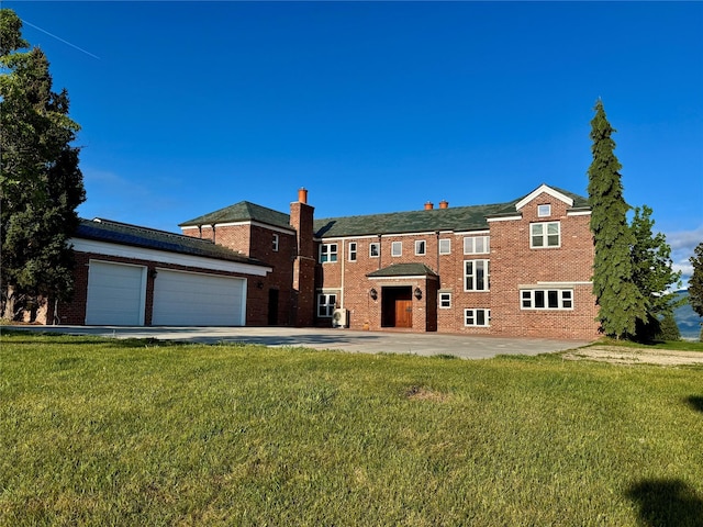 444 Windwalker Trl, Stevensville, MT 59870 - view of front of home with a front lawn, an attached garage, brick siding, and concrete driveway