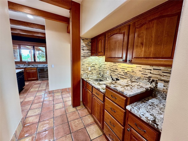 444 Windwalker Trl, Stevensville, MT 59870 - kitchen with beverage cooler, tasteful backsplash, light stone countertops, brown cabinets, and beamed ceiling