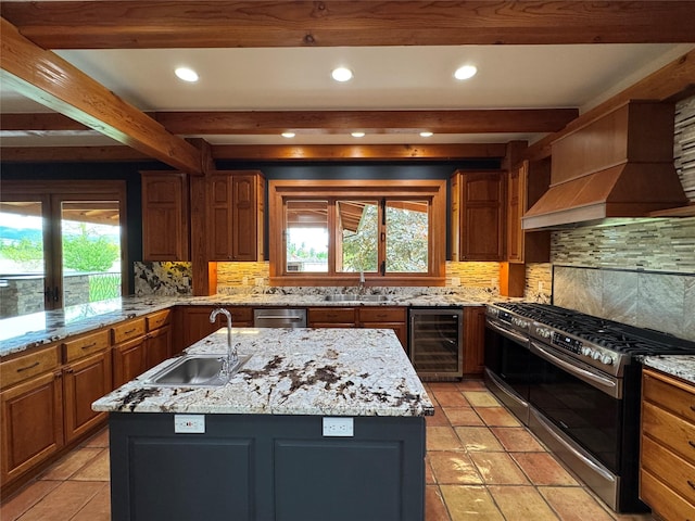 444 Windwalker Trl, Stevensville, MT 59870 - kitchen featuring appliances with stainless steel finishes, a sink, wine cooler, beam ceiling, and custom range hood