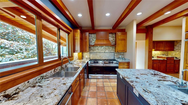 444 Windwalker Trl, Stevensville, MT 59870 - kitchen featuring a sink, stainless steel gas range oven, premium range hood, beamed ceiling, and tasteful backsplash