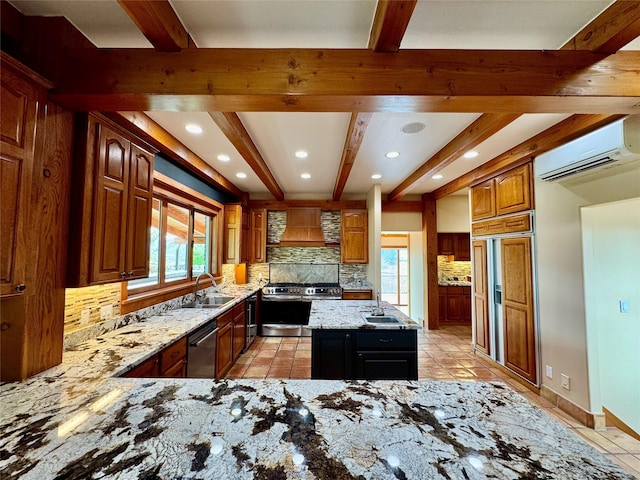 444 Windwalker Trl, Stevensville, MT 59870 - kitchen featuring beam ceiling, appliances with stainless steel finishes, backsplash, light stone counters, and a wall mounted AC