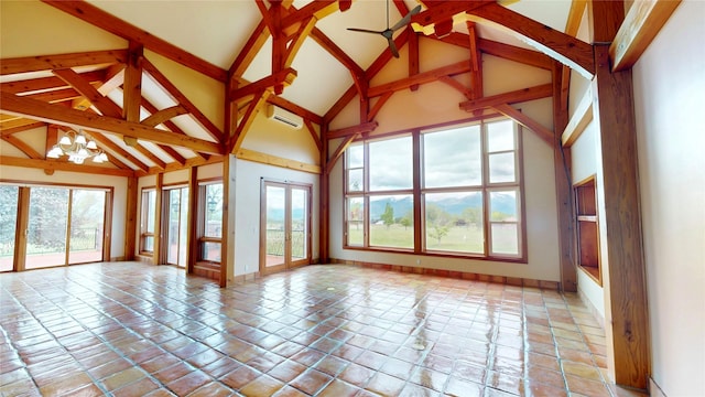 444 Windwalker Trl, Stevensville, MT 59870 - unfurnished living room with a chandelier, beamed ceiling, healthy amount of natural light, high vaulted ceiling, and baseboards