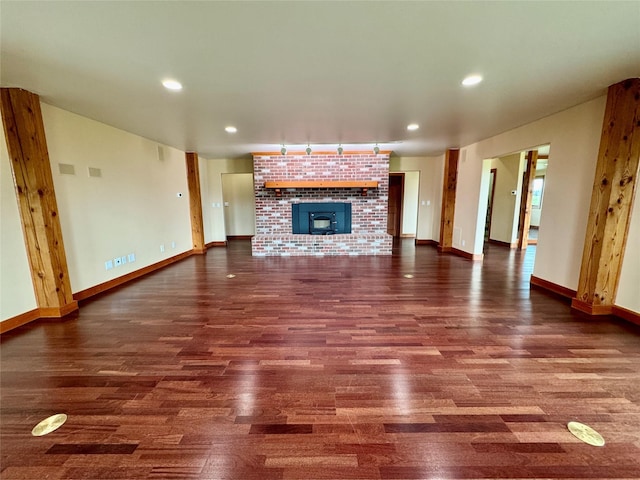 444 Windwalker Trl, Stevensville, MT 59870 - unfurnished living room featuring wood finished floors, baseboards, a fireplace, and recessed lighting