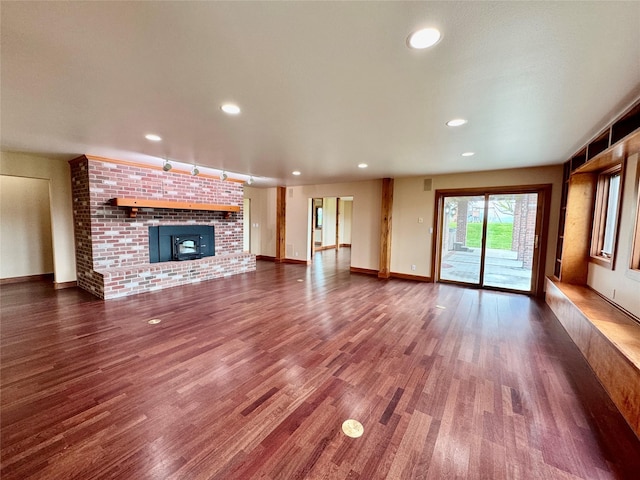 444 Windwalker Trl, Stevensville, MT 59870 - unfurnished living room with wood finished floors, a fireplace, baseboards, and recessed lighting