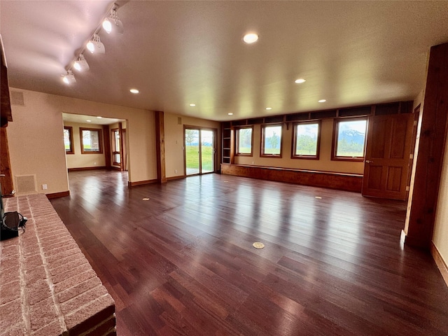 444 Windwalker Trl, Stevensville, MT 59870 - unfurnished living room featuring dark wood-type flooring, baseboards, and recessed lighting