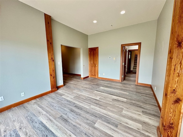 444 Windwalker Trl, Stevensville, MT 59870 - unfurnished bedroom with light wood-style flooring, baseboards, recessed lighting, and ensuite bathroom