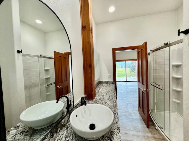 444 Windwalker Trl, Stevensville, MT 59870 - bathroom with a stall shower, wood finished floors, and double vanity