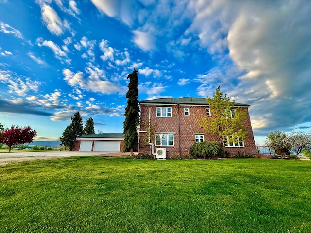 444 Windwalker Trl, Stevensville, MT 59870 - view of side of property with a yard, concrete driveway, and brick siding