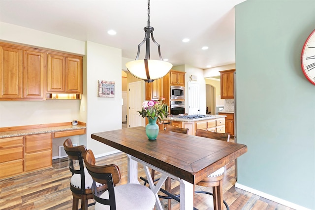 5040 Jordan Ct, Missoula, MT 59803 - dining area with light wood-style floors, baseboards, recessed lighting, and arched walkways