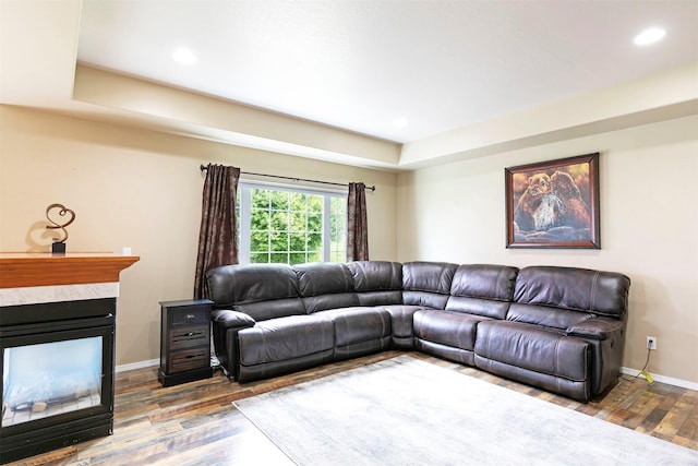5040 Jordan Ct, Missoula, MT 59803 - living room featuring wood finished floors, baseboards, a fireplace, a tray ceiling, and recessed lighting