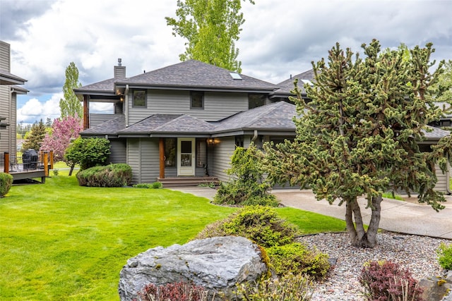 259 Eagle Bend Dr, Bigfork, MT 59911 - view of front of property with a front lawn, a chimney, and a shingled roof