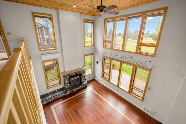 259 Eagle Bend Dr, Bigfork, MT 59911 - living area featuring wood ceiling, a fireplace, a ceiling fan, baseboards, and wood finished floors