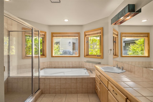 259 Eagle Bend Dr, Bigfork, MT 59911 - full bathroom featuring tile patterned floors, vanity, a bath, a shower stall, and recessed lighting