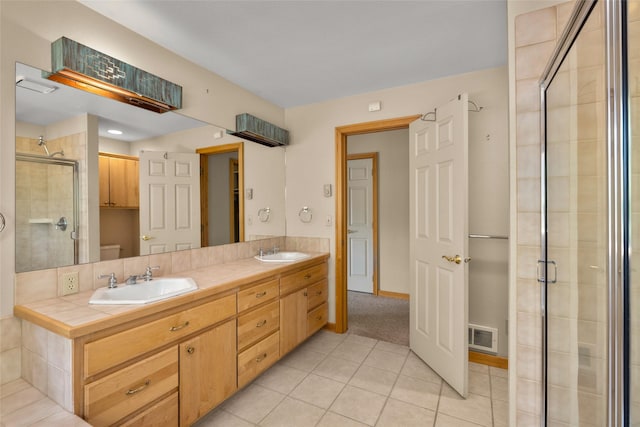 259 Eagle Bend Dr, Bigfork, MT 59911 - full bath with tile patterned floors, a stall shower, double vanity, and toilet