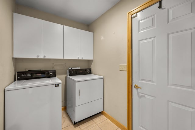 259 Eagle Bend Dr, Bigfork, MT 59911 - laundry area featuring cabinet space, washer and clothes dryer, baseboards, and light tile patterned floors