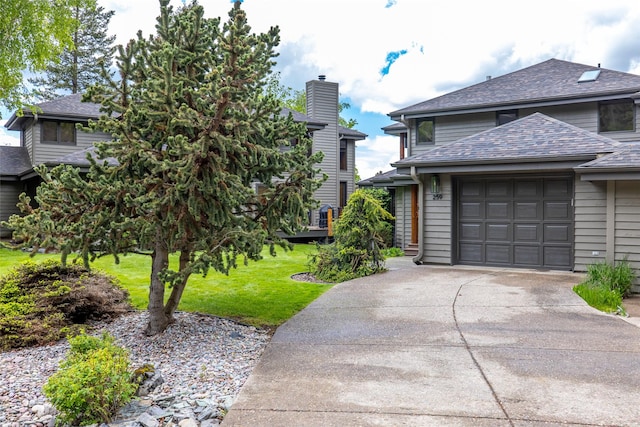 259 Eagle Bend Dr, Bigfork, MT 59911 - view of home's exterior with concrete driveway, a lawn, roof with shingles, and an attached garage