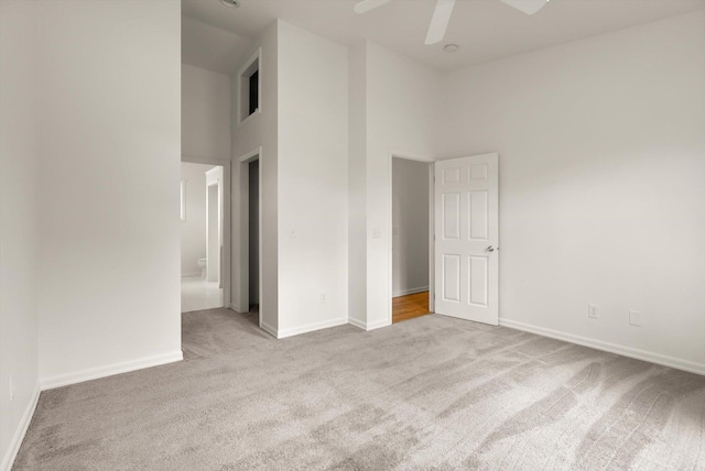 515 W Oregon St, Kalispell, MT 59901 - carpeted empty room with ceiling fan, baseboards, and a towering ceiling
