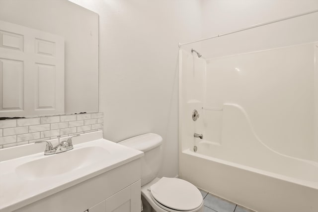 515 W Oregon St, Kalispell, MT 59901 - bathroom with toilet, vanity, tub / shower combination, backsplash, and tile patterned flooring