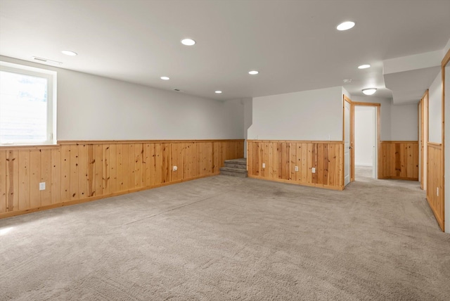 515 W Oregon St, Kalispell, MT 59901 - unfurnished room with a wainscoted wall, wooden walls, stairs, light colored carpet, and recessed lighting