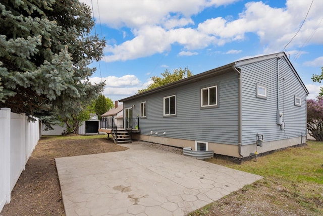 515 W Oregon St, Kalispell, MT 59901 - rear view of property featuring a patio area, a fenced backyard, and a wooden deck