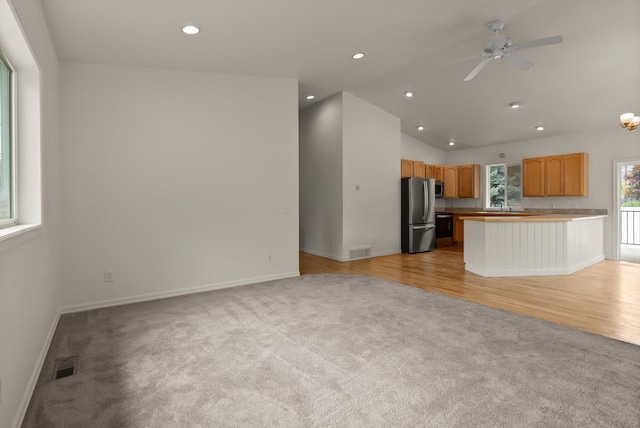 515 W Oregon St, Kalispell, MT 59901 - unfurnished living room with light colored carpet, baseboards, recessed lighting, ceiling fan, and lofted ceiling