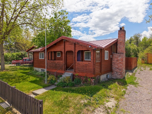 323 B St, Dixon, MT 59831 - chalet / cabin with a chimney, a standing seam roof, a porch, and metal roof