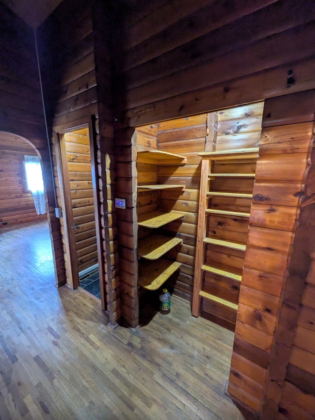 323 B St, Dixon, MT 59831 - hallway featuring arched walkways, hardwood / wood-style flooring, and wooden walls