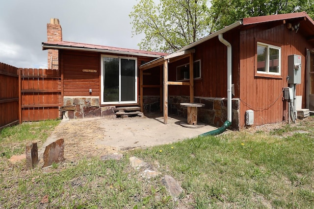 323 B St, Dixon, MT 59831 - back of house with a chimney, entry steps, metal roof, and a patio