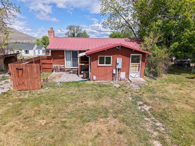 323 B St, Dixon, MT 59831 - back of property with entry steps, a chimney, metal roof, a patio, and a mountain view