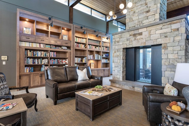 100 Woodlands Way Unit P-405, Kalispell, MT 59901 - living room with a towering ceiling, built in shelves, wooden ceiling, and carpet flooring
