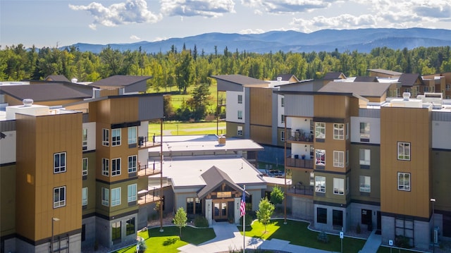 100 Woodlands Way Unit P-405, Kalispell, MT 59901 - view of building exterior featuring a mountain view and a forest view