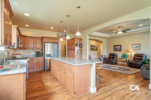 339 Elouise Cobell St, Helena, MT 59601 - kitchen with stainless steel fridge with ice dispenser, a sink, open floor plan, light wood-type flooring, and arched walkways
