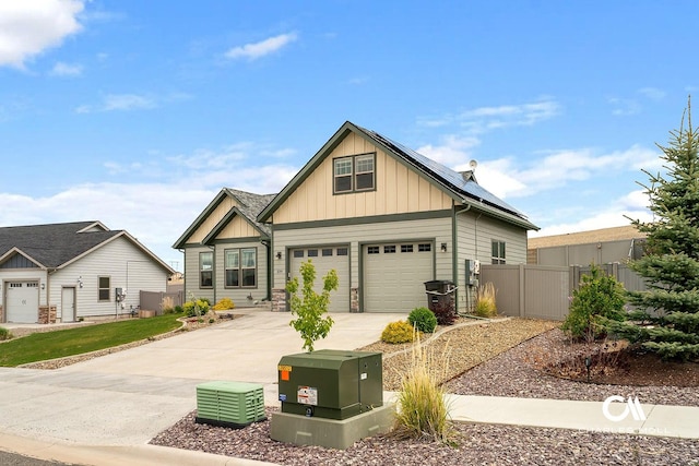 339 Elouise Cobell St, Helena, MT 59601 - craftsman-style house featuring board and batten siding, roof mounted solar panels, driveway, and stone siding