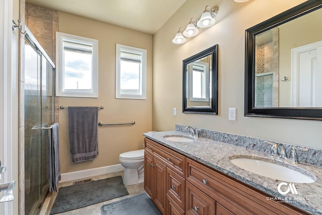 339 Elouise Cobell St, Helena, MT 59601 - bathroom with a stall shower, toilet, double vanity, and baseboards